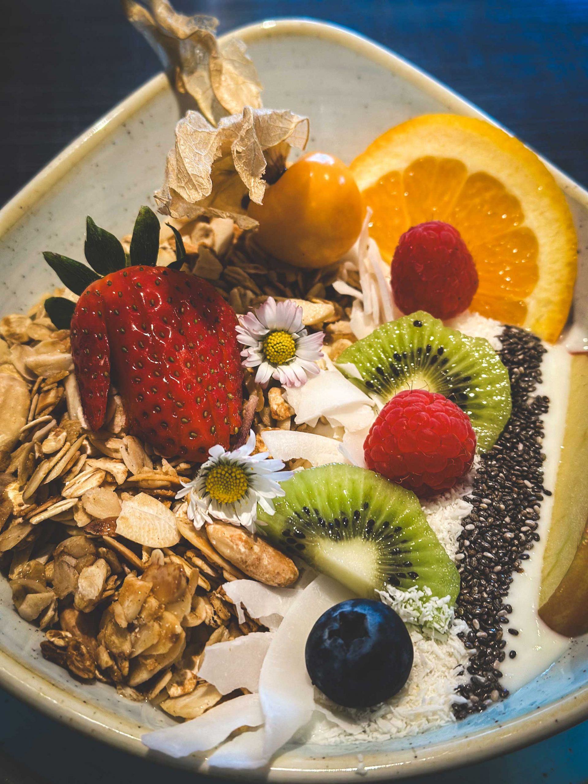 Joghurt-Bowl mit frischen Früchten und Müsli hübsch dekoriert